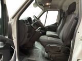 the interior of a white van with black seats and a steering wheel