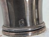 a silver vase sitting on top of a white counter