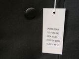 a close up of a black jacket with a tag on it