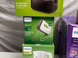 three boxes of philips toaster and a toaster sitting on a table