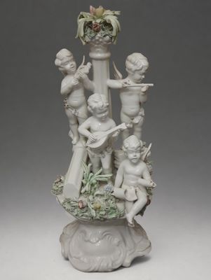 porcelain figurine of a group of cherenshes with flowers in a vase