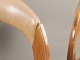 a close up of a chair with a leather seat
