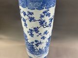 tall blue and white vase with a tree design