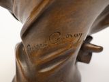 a bronze statue of a man holding a baseball bat