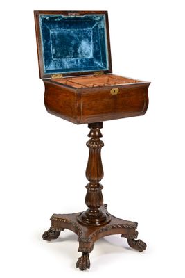 an old wooden table with a blue velvet covered top and a wooden stand