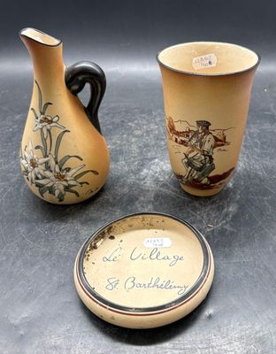 two vases and a plate sitting on a table