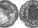 a close up of a coin with a crown on top of it