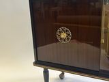 a small cabinet with a clock on top of it