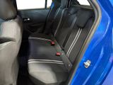 the back seats of a blue car are empty and the passenger seat is empty