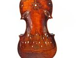 an old violin that has been carved into a piece of wood