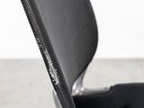the back of a black office chair with a zippered seat