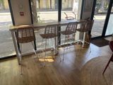 three chairs that are sitting in front of a bar