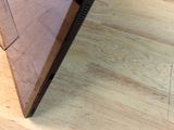 someone is cutting a piece of wood with a knife on a cutting board