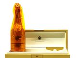 a bottle of champagne in a box with a knife in it