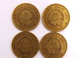 three gold coins, one of which is a sovereign and the other of which is a sovereign