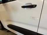 a white car with a black door handle and a sticker on it