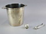 a silver bucket with a spoon and spoon rest next to it