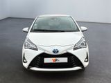 the front view of a white toyota yaris parked in a room