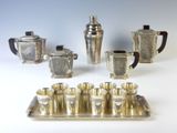 a silver tray with silver cups and a tray with silver cups on it