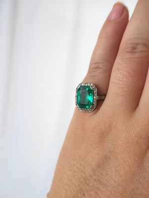 an image of a woman ' s hand with a ring on it ' s finger