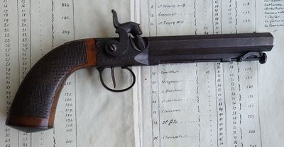 un pistolet posé sur une feuille de papier