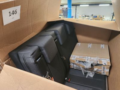 a cardboard box with luggage inside of it in a warehouse