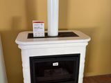a white stove sitting in a room next to a yellow wall