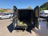 the back of a black van with its door open in a parking lot