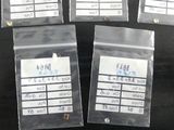four bags of cell phones are lined up on a black surface