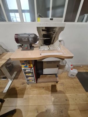a desk with a computer and a mixer on top of it