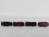 three miniature trains are lined up in a row on a white surface