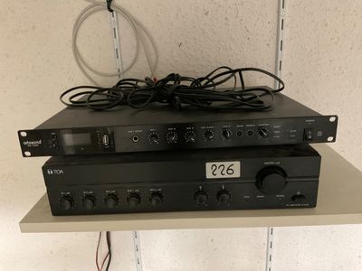 two black electronic devices sitting on top of each other on a shelf