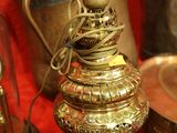 a gold lamp that is sitting on a red table