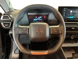 the interior of a car with a steering wheel and dashboard controls