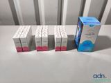 four boxes of toothpaste sitting next to each other on a table