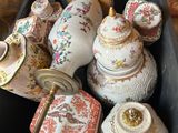 a box full of different types of vases on a table
