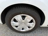 a close up of a tire on a white car
