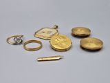 several different types of gold jewelry on a white surface