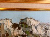 an oil painting of a mountain scene on the wall
