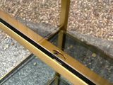 a glass table with a gold frame on it