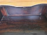 a wooden bench with a wooden top on a wooden floor