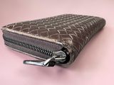 an image of a wallet with a zipper on a pink background