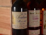 several bottles of wine are lined up on a shelf
