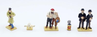 four figurines of people standing on a white surface