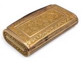 an antique gold cigarette case on a white background with a white background