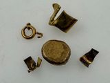 several pieces of brass are arranged in a circle on a white surface
