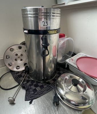 a coffee pot sitting on top of a counter next to other kitchen items