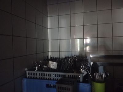 many utensils and spoons on the counter in the kitchen