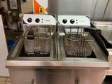two deep fryers sitting on the counter in the kitchen
