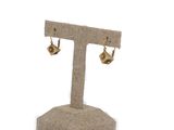 a close up of a pair of earrings on a stand